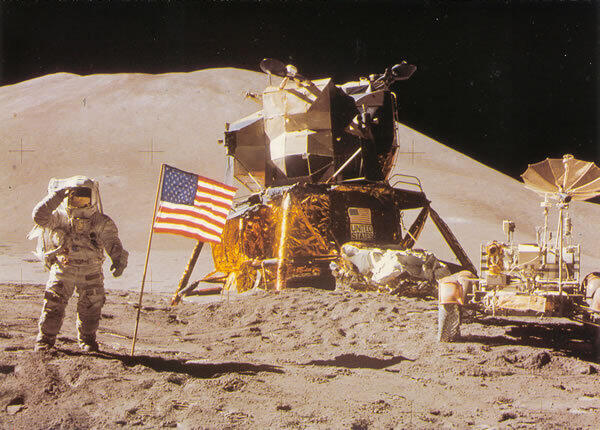 Astronaunt James Irwin with an American flag on the moon.